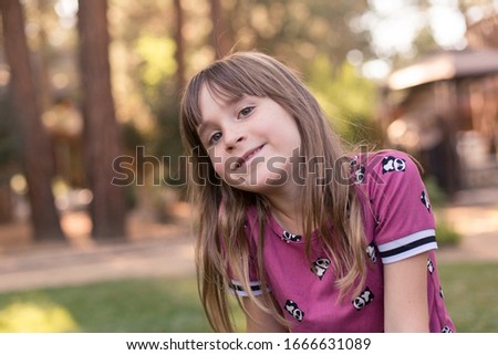 A girl is getting some outside time and fresh air on a nature hike with her family