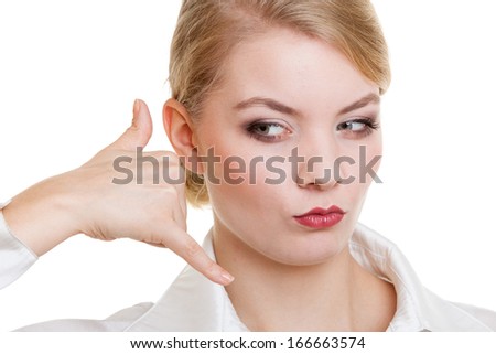 Attractive businesswoman making call me gesture. Blonde girl with phone hand sign. Business communication. Isolated on white. Studio shot.