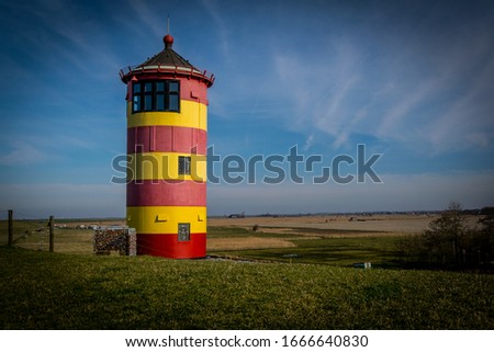 famous Lighthouse in Krummhörn near Greetsiel in northern Germany Royalty-Free Stock Photo #1666640830