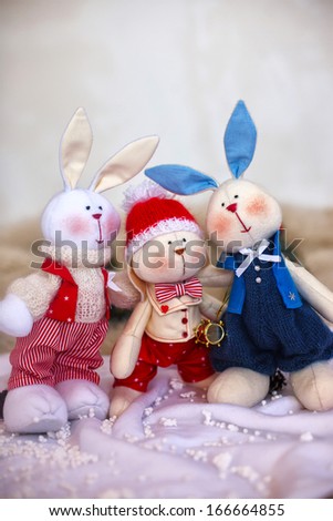Christmas toy rabbits on the background trees. Property released