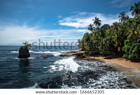 Wild caribbean jungle Rainforest beach Manzanillo Puerto Viejo Costa Rica Central Latin America blue sky sea water ocean  Royalty-Free Stock Photo #1666652305