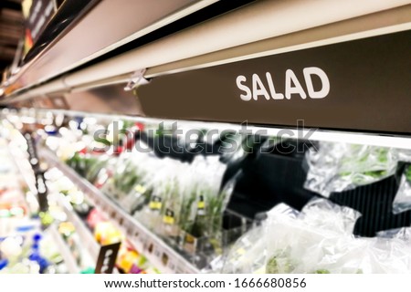 Salad signage at supermarket produced food section with defocused background
