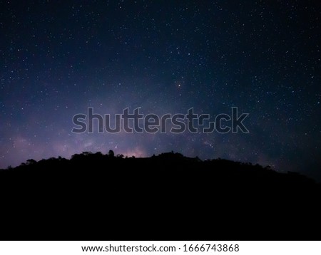 beautiful night sky from milky way galaxy with stars and meteor over mountain at national park, Thailand on February 2020