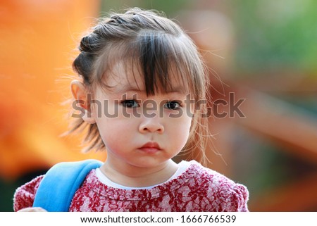 The little girl looking at the camera Royalty-Free Stock Photo #1666766539