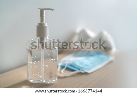 Coronavirus corona virus prevention travel surgical masks and hand sanitizer gel for hand hygiene spread protection. Royalty-Free Stock Photo #1666774144