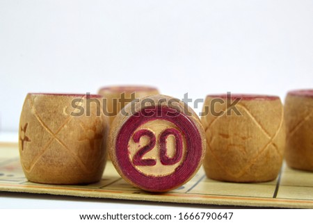 Wooden lotto barrels with numbers. Isolated on a white background. Family bingo game. Conceptual photo.