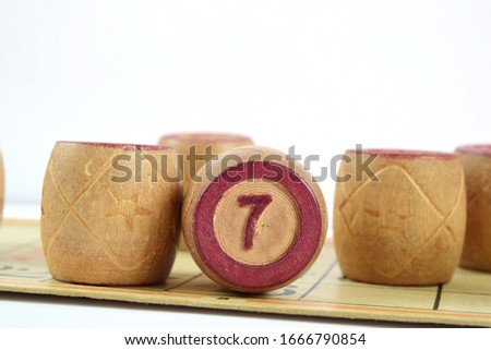 Wooden lotto barrels with numbers. Isolated on a white background. Family bingo game. Conceptual photo.