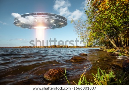 UFO, an alien plate hovering above water, hovering motionless in the air. Unidentified flying object, alien invasion, extraterrestrial life, space travel, humanoid spaceship mixed medium Royalty-Free Stock Photo #1666801807