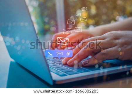 Contact us or Customer support hotline people connect. Businessman using a laptop computer with the (email, call phone, mail) icons. Royalty-Free Stock Photo #1666802203