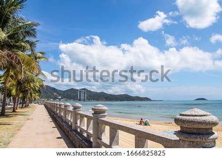 Bai Duong tourist area. A beautiful landscape of Nha Trang. Look at it with white clouds, against a vast blue sky. A beautiful picture, with high coconut trees leaning on the romantic golden sand