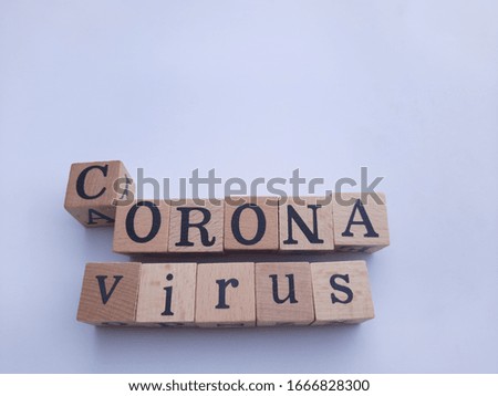Top view image of square wooden blocks with the letters CORONAvirus isolated on white background for decorative and design.