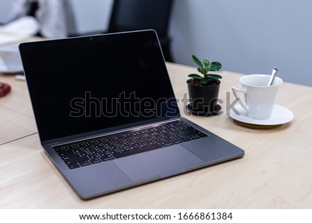 Laptop with blank screen on the table in the office