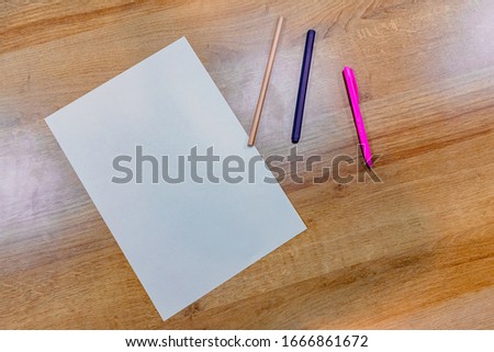 Picture of white paper and pen, pencil placed on the work desk