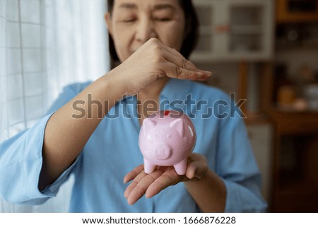 hand putting coin money to piggy bank saving.
