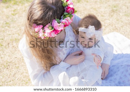baby and mom playing in the park