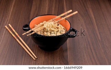 Chinese noodles in bowl stock images. Chinese noodles on the table still life. A bowl of chinese noodles with chopstick stock images