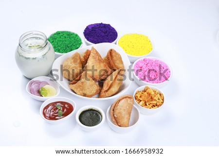 holi festival celibration with Samosa, gulal color or colour gujiya sweet and namkeen chivda