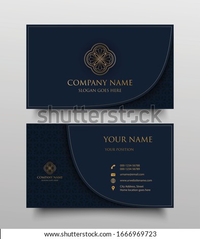 Luxury business card with gold floral ornamental logo and place for text on navy blue background