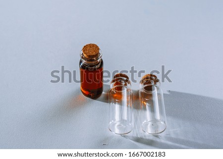 two beakers with clear liquid and one beaker with dark liquid. Dark is worth, the bright lie