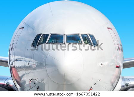 modern airplane front wide view isolated against blue sky background  passenger plane closeup reference for banner design large jet aircraft in details aviation concept