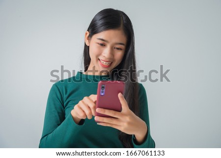 Shot of pretty young female holds modern smart phone amazed by unbelievable message winner, happy feeling.