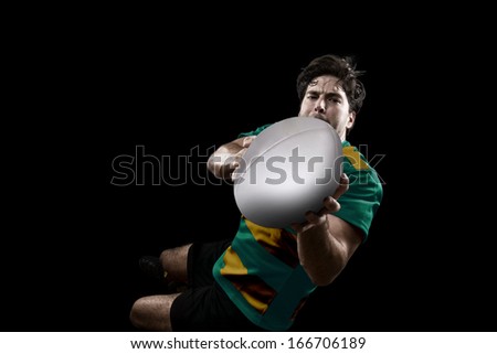 Rugby player in a green and gold uniform. Black Background