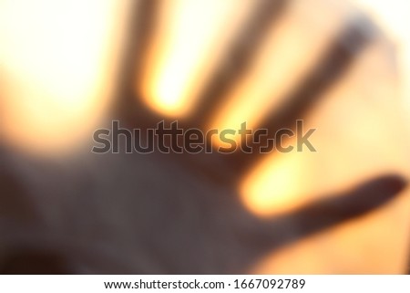 Shadow blur of horror hand. Dangerous hand  behind the frosted glass.  hands blurred on the glass. the hand shadows on frosted glass.