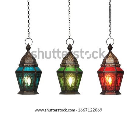 Ornamental Arabic lantern with burning candle glowing isolated o Royalty-Free Stock Photo #1667122069