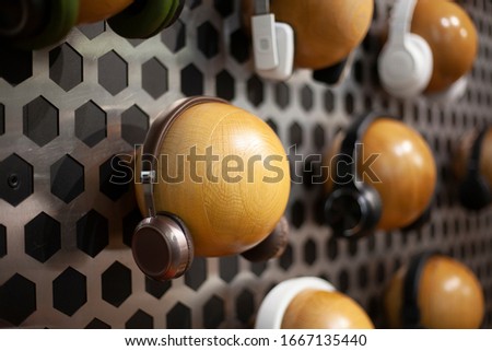 Headphones in a music store. Dummies for demonstrating audio with an earpiece. Spherical objects on which audio devices are dressed. 