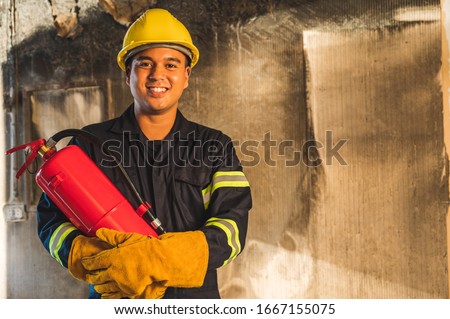 Young asian Fireman,Firefighters use fire  extinguishing that are burning in the building.