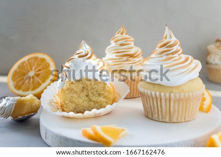 Lemon cupcakes with Italian meringue. Delicious homemade cakes. Side view, close- up, copy space.