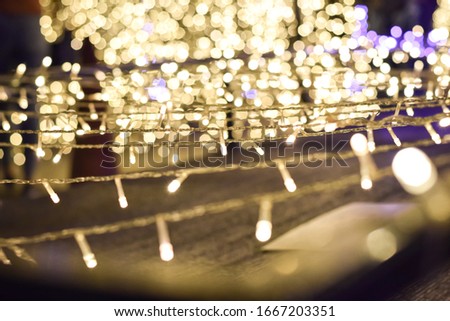 Abstract blurred bokeh blinking lights. Christmas day and happy new year out of focus gold light abstract colorful  background.