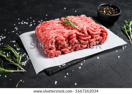 Raw minced pork. Black background. Top view. Space for text Royalty-Free Stock Photo #1667262034