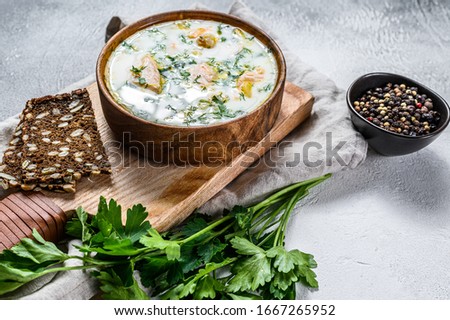 Finnish Creamy Fish Soup with Salmon and Potatoes. Gray background, top view.