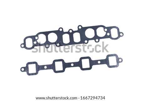 gasket set of automotive paronite exhaust and intake manifold with metal inserts and auto parts on a white background close-up