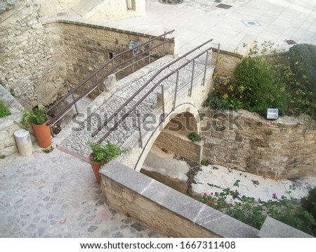 Arch cobblestone bridge in Agios Neophytos Monastery Royalty-Free Stock Photo #1667311408