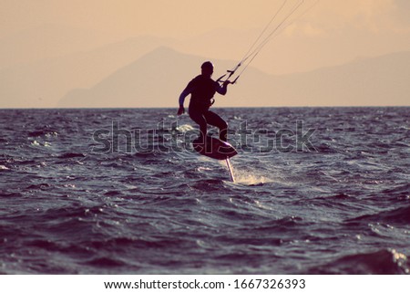 man kite surfing on the sea
