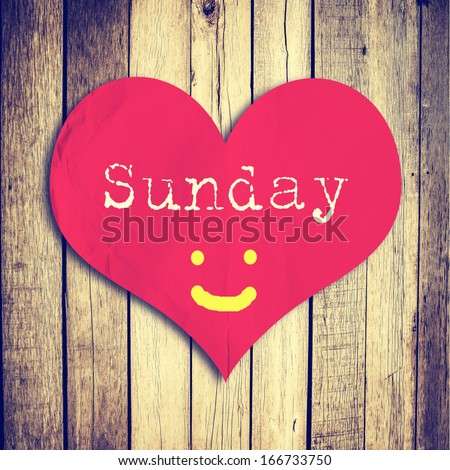 Love Sunday on red heart shape with wooden wall,vintage filter