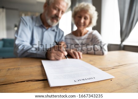 Close up of happy mature 60s couple spouses clients close deal sign insurance contract with specialist, smiling middle-aged old husband and wife put signature make agreement, elderly care concept