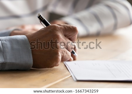 Close up of old 60s man close deal put signature on contract make investment or take bank loan, retired mature husband sign close deal on paper agreement, elderly health insurance concept