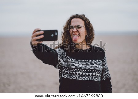 Woman taking a selfie in the beach