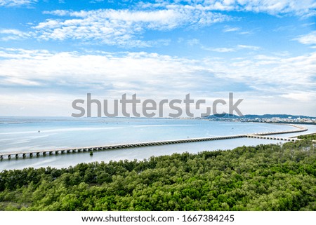 Aerial view of a seascape with beautiful bridge in Thailand. Captured from above with a drone. - Image
(Visible noise due to high ISO, soft focus) (Toned Image)
