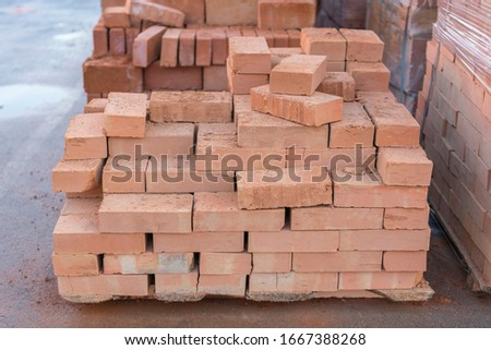 clay brick stored for building construction. Industrial production of bricks. brick production line in factory, stacked bricks