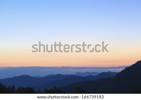 Mountain landscape with a small moon