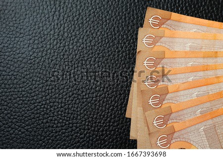 Euro lined with fan on black leather texture luxury background