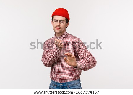 Geeky guy vibing and having fun. Carefree cute funny man in red beanie and glasses, dancing clumsy on dancefloor, enjoy awesome office party, celebrating holiday or triumphing over win