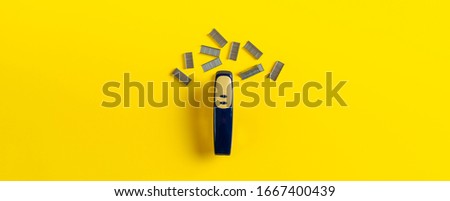 simple stapler and staples isolated on the colorful background in office table wide long banner 