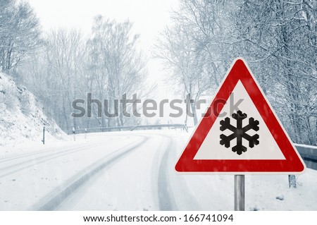 winter driving - winding country road in winter - risk of snow and ice