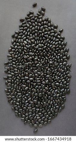 Black, textured background formed with black beans.