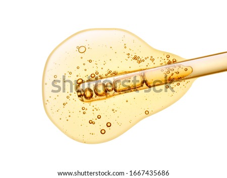Liquid yellow gel or serum on white isolated background Royalty-Free Stock Photo #1667435686
